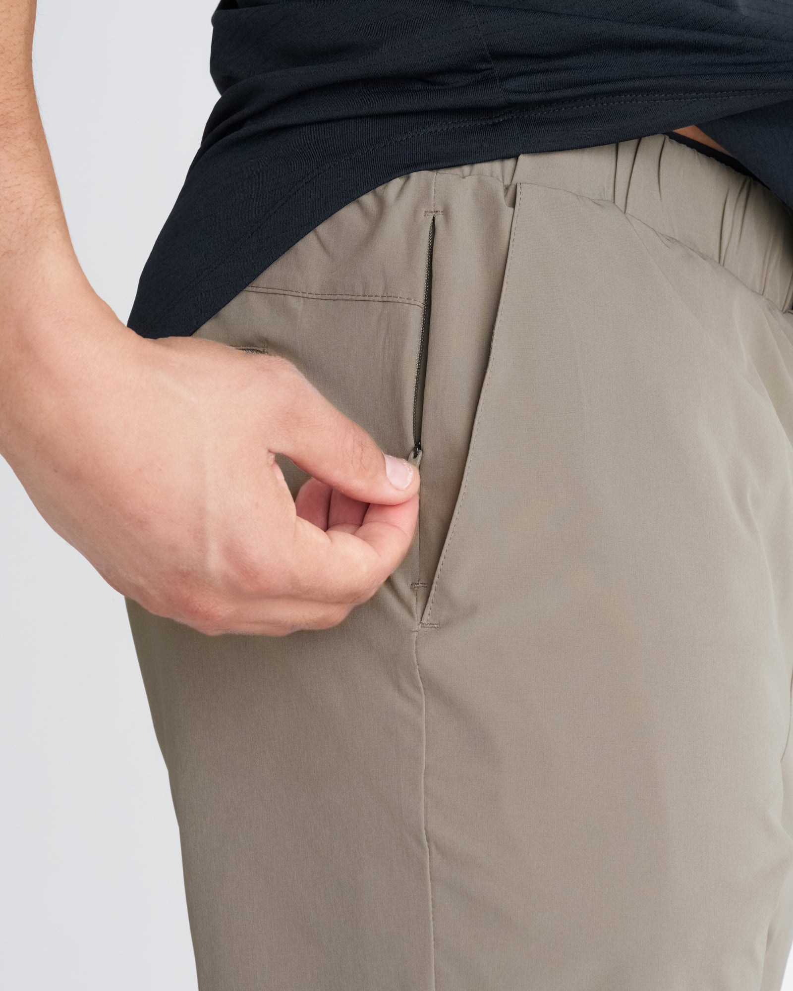 Close-up of Pulse Tech Liner Short in Sand showing a zippered back pocket detail.