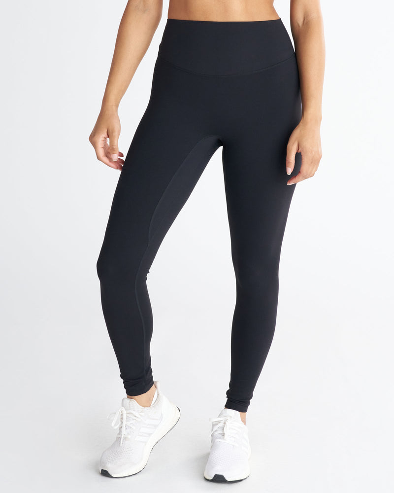 Front view of the Nova Legging 27" in black on a model, featuring a wide high waistband and full-length fit.