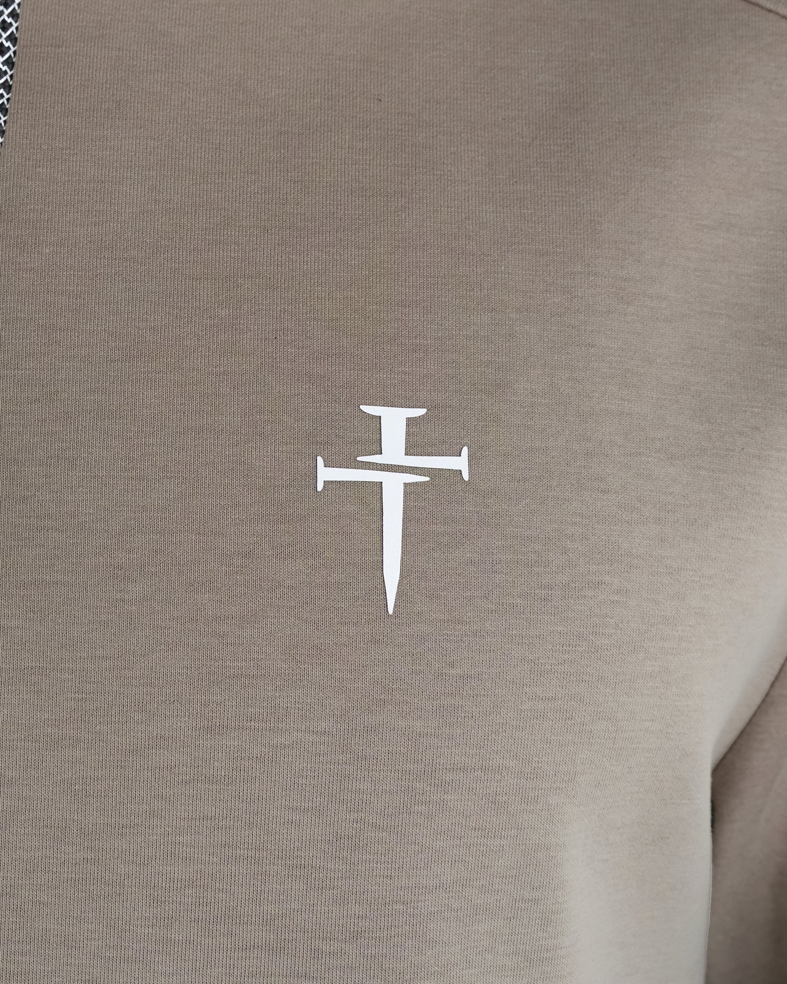 Close-up of the Three Nails Clothing Co logo on the chest of the Pro-Tech Hoodie in Sand.