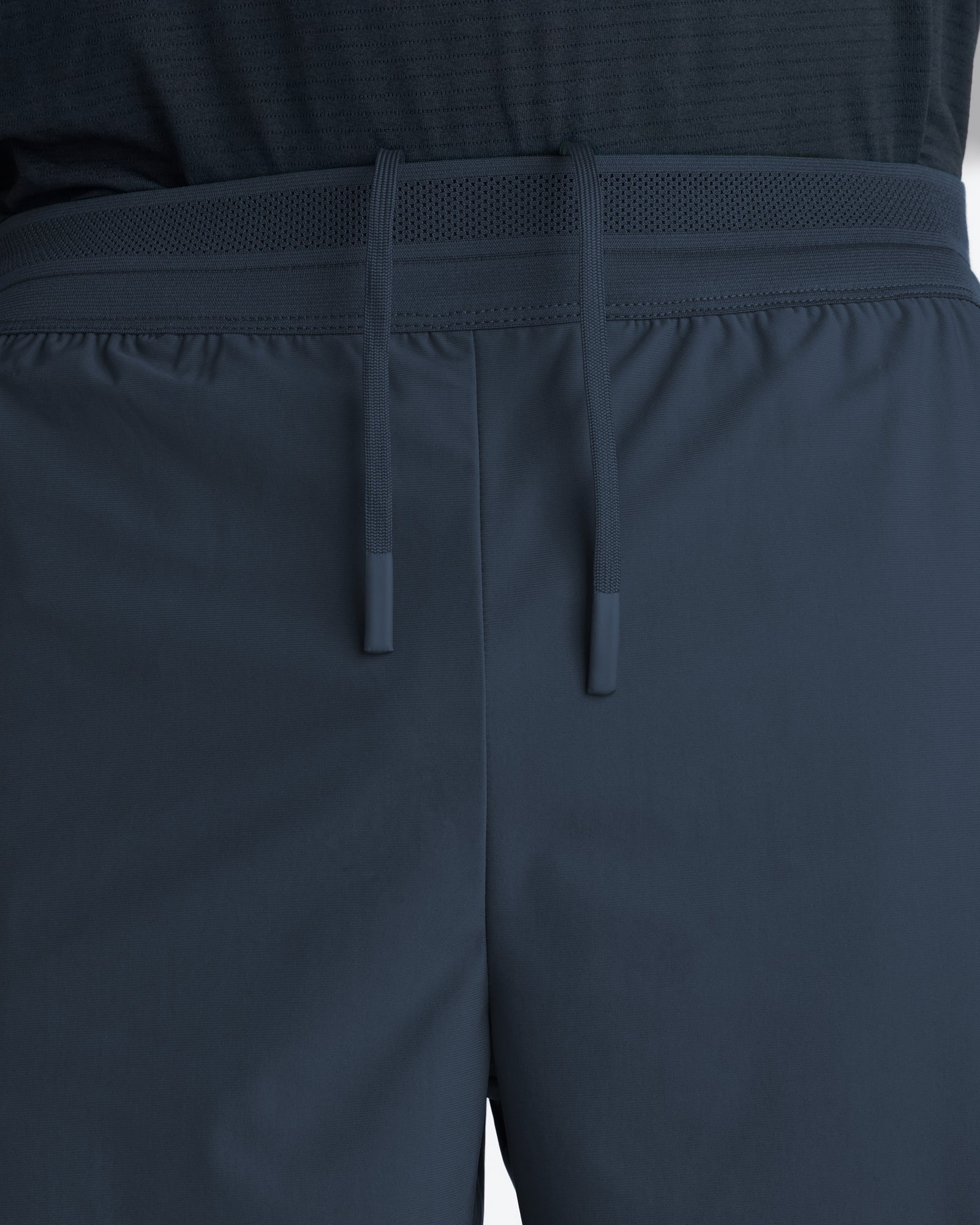 Close-up of Vapor-Lite Liner Short Cross in Midnight Navy showing drawstring waistband and mesh belt detail.