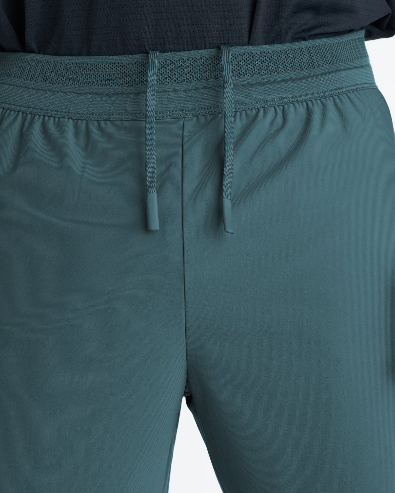 Close-up of Vapor-Lite Liner 5 Inch Short Cross in Teal showing elastic waistband with mesh panel and matching drawcord detail.
