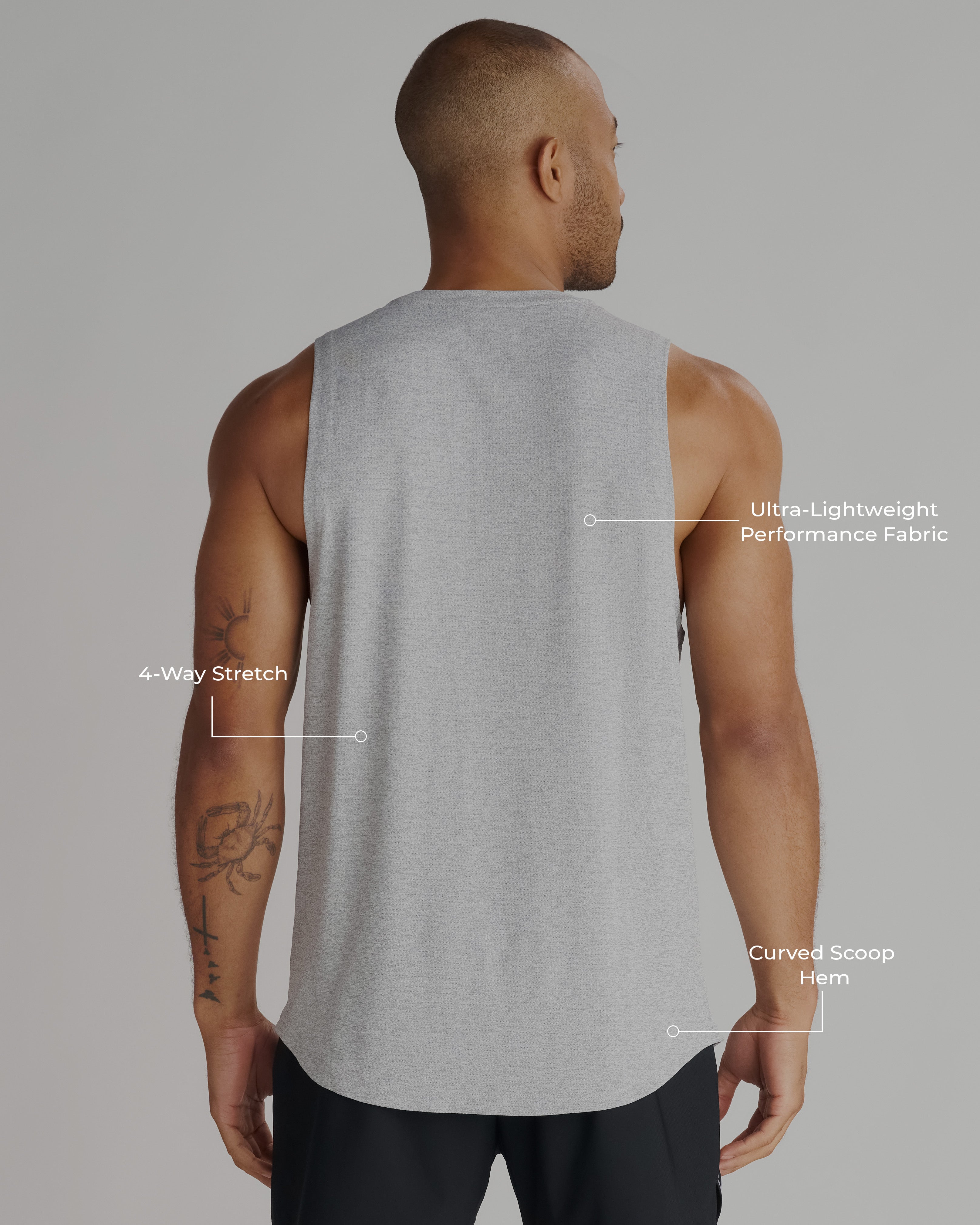 Back view of male model wearing the Aion-Lite Tank in Grey Marl, showing curved hem and relaxed fit.