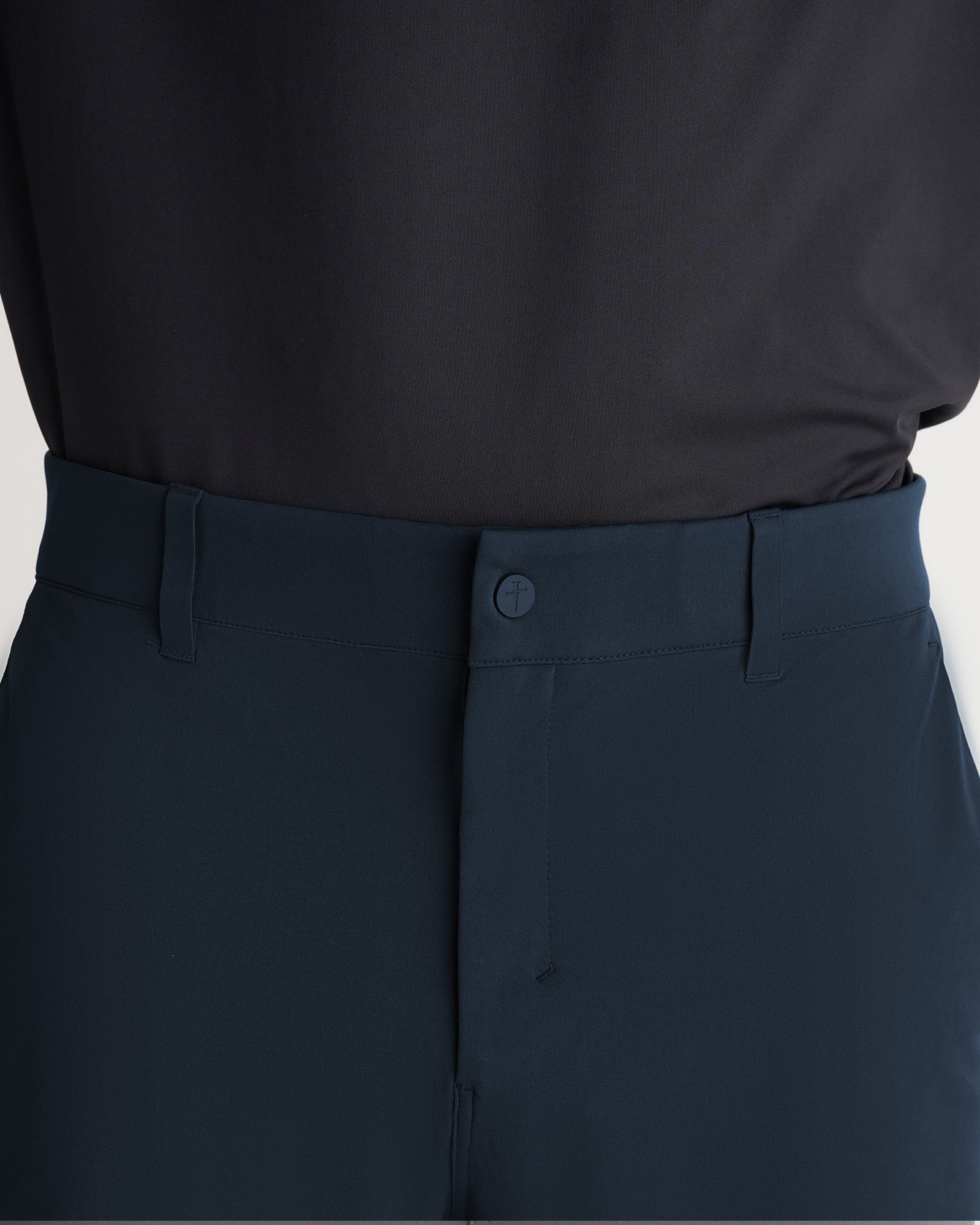 Close-up of Links Golf Pant in Midnight Navy showing waistband, button closure, and belt loops.