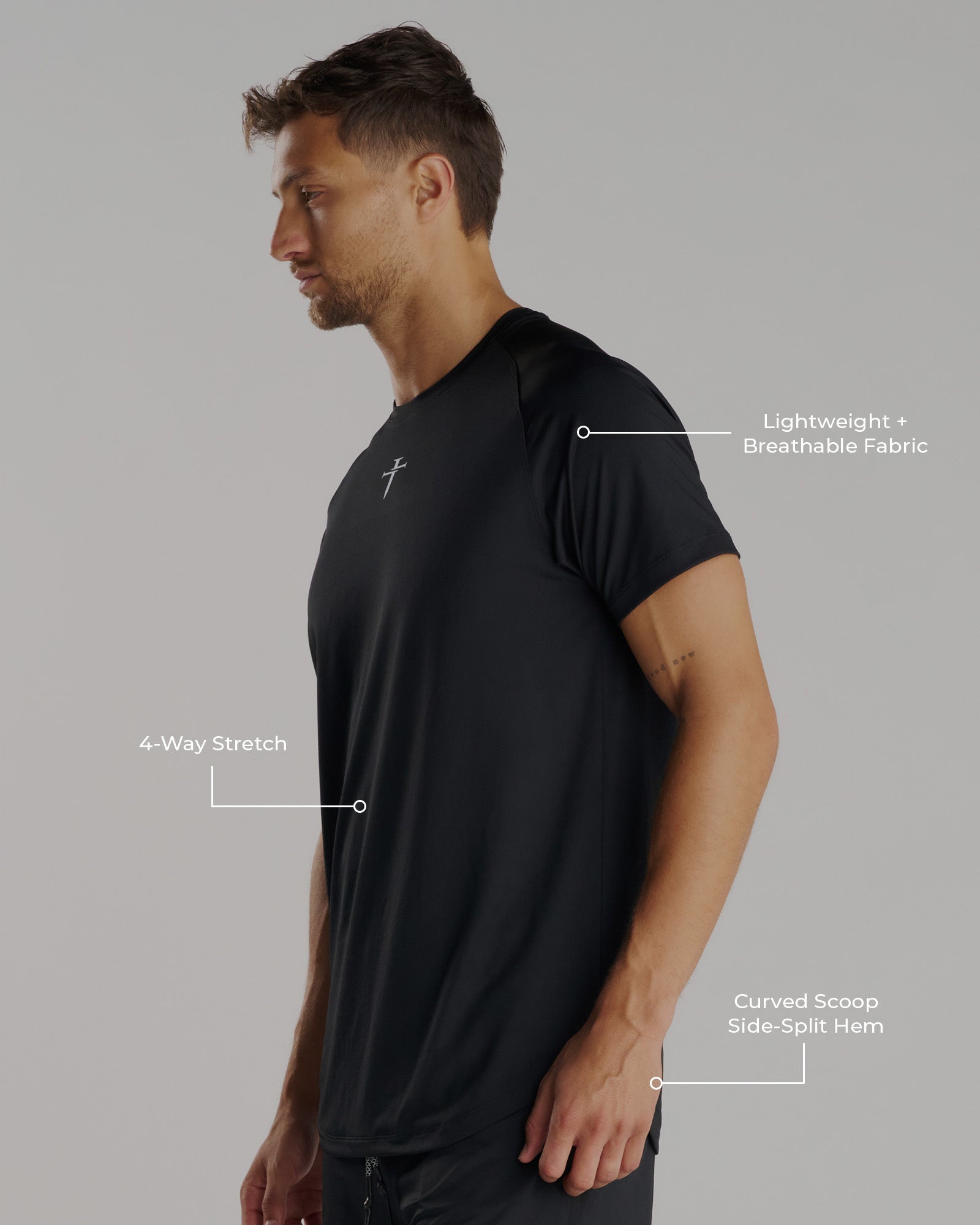 Man wearing the Pro-Tech Tee Cross in black, side angle view, showing curved hem and cross logo.