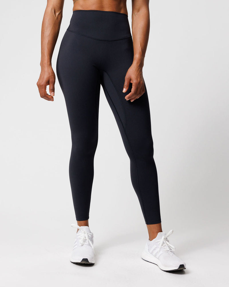 Front view of Nova Legging 27" in black on a model, featuring a wide waistband and side pocket detail.