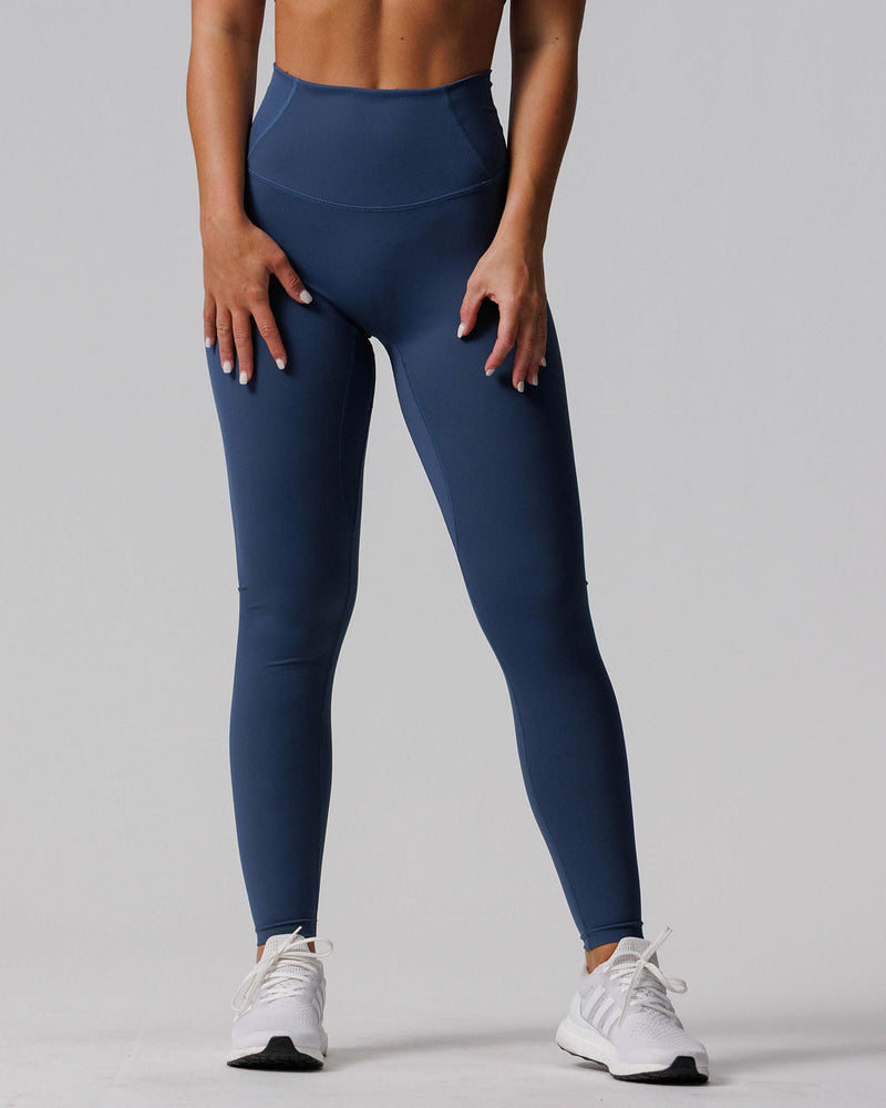 Front view of Endura-Train™ Legging Bundle Pack in navy blue worn by a model with white sneakers.