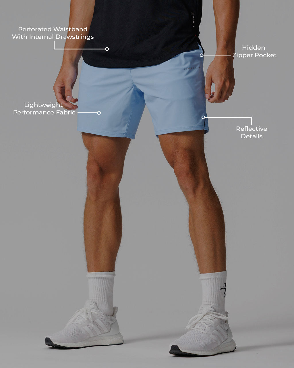 Man wearing sky blue Vapor-Lite Hybrid Short, front view, with labeled performance features highlighted.