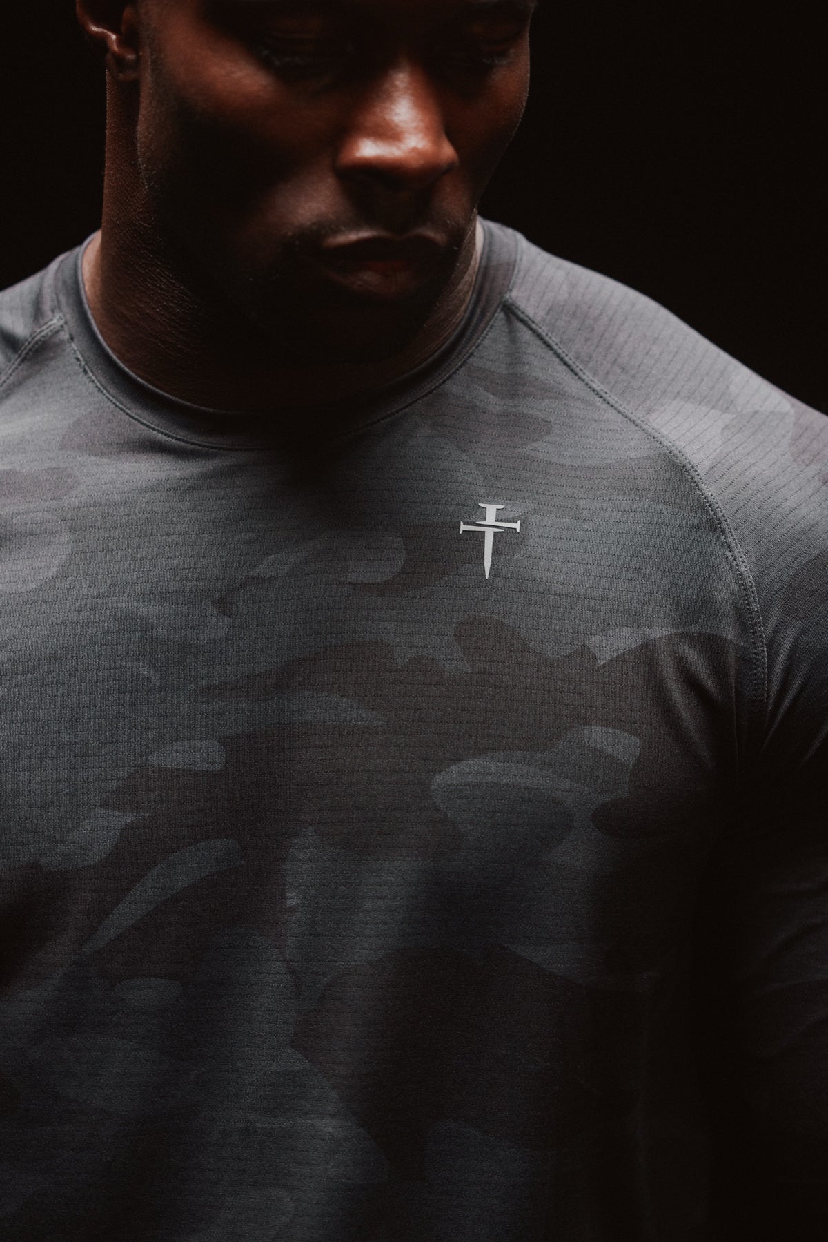 Model in the Three Nails Black Camo tee