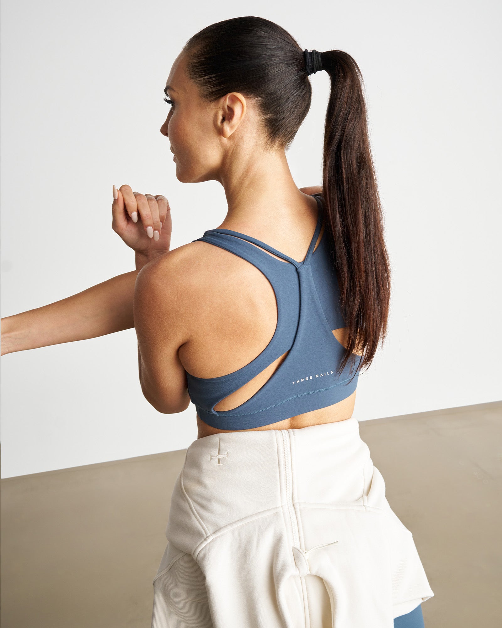 Nova High Impact Bra in Midnight Navy shown from back view, featuring cutout racerback design and double straps.