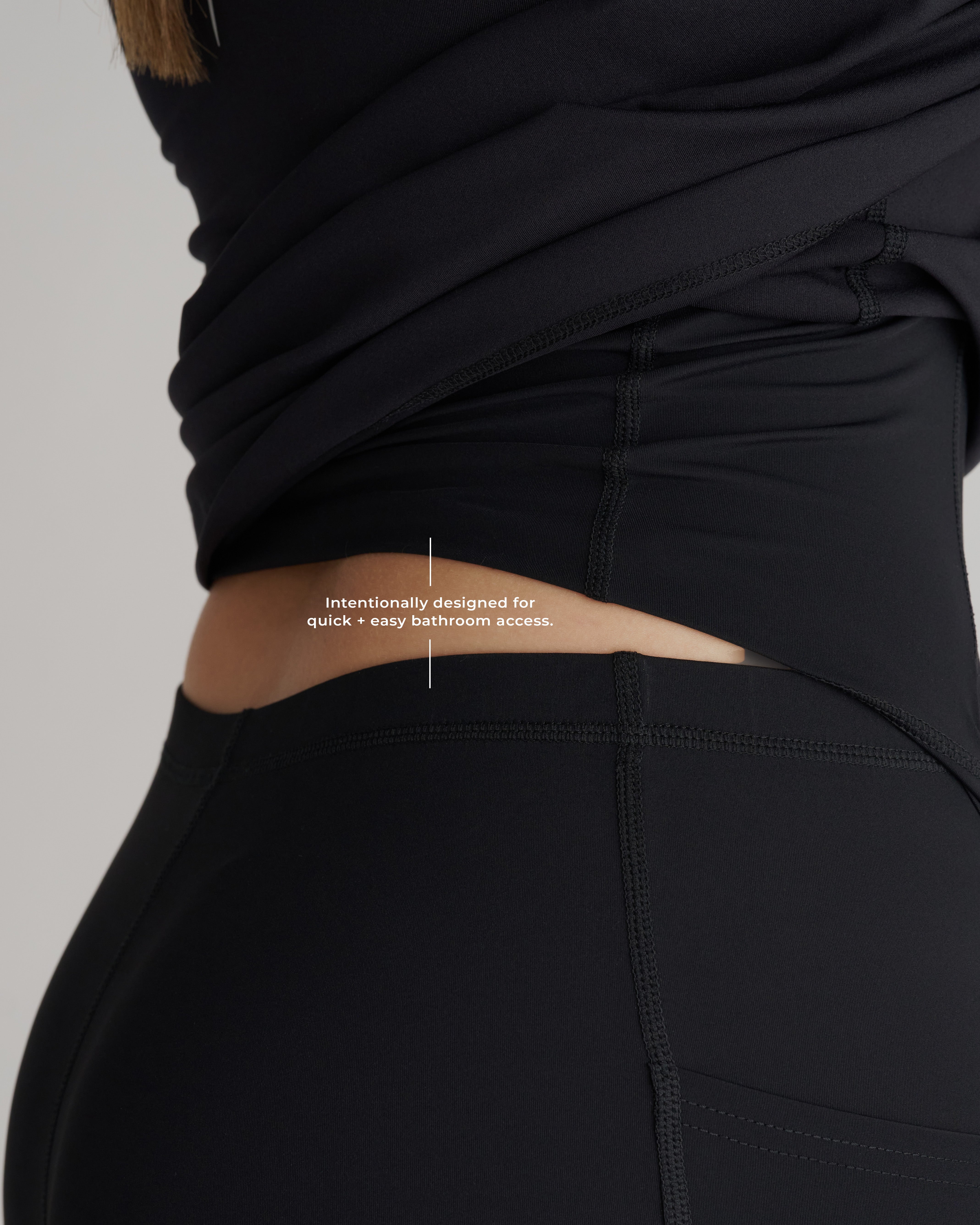Close-up of Links Golf Dress Black leggings waistband showing a side cutout opening for bathroom access.